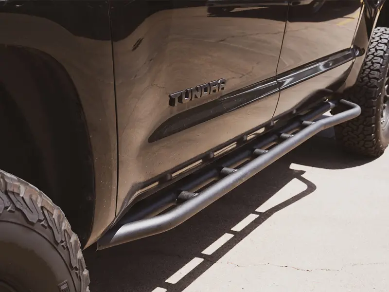 Cali Raised Trail Edition Rock Sliders For 2014–2021 Toyota Tundra – Kick-Out Design With Bedliner Finish 1